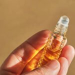 Oil roller perfume on a beige background. Aromatherapy element