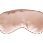 Beige silk sleep mask isolated over white