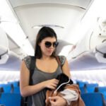 Woman taking her stuff and disembarking of airplane